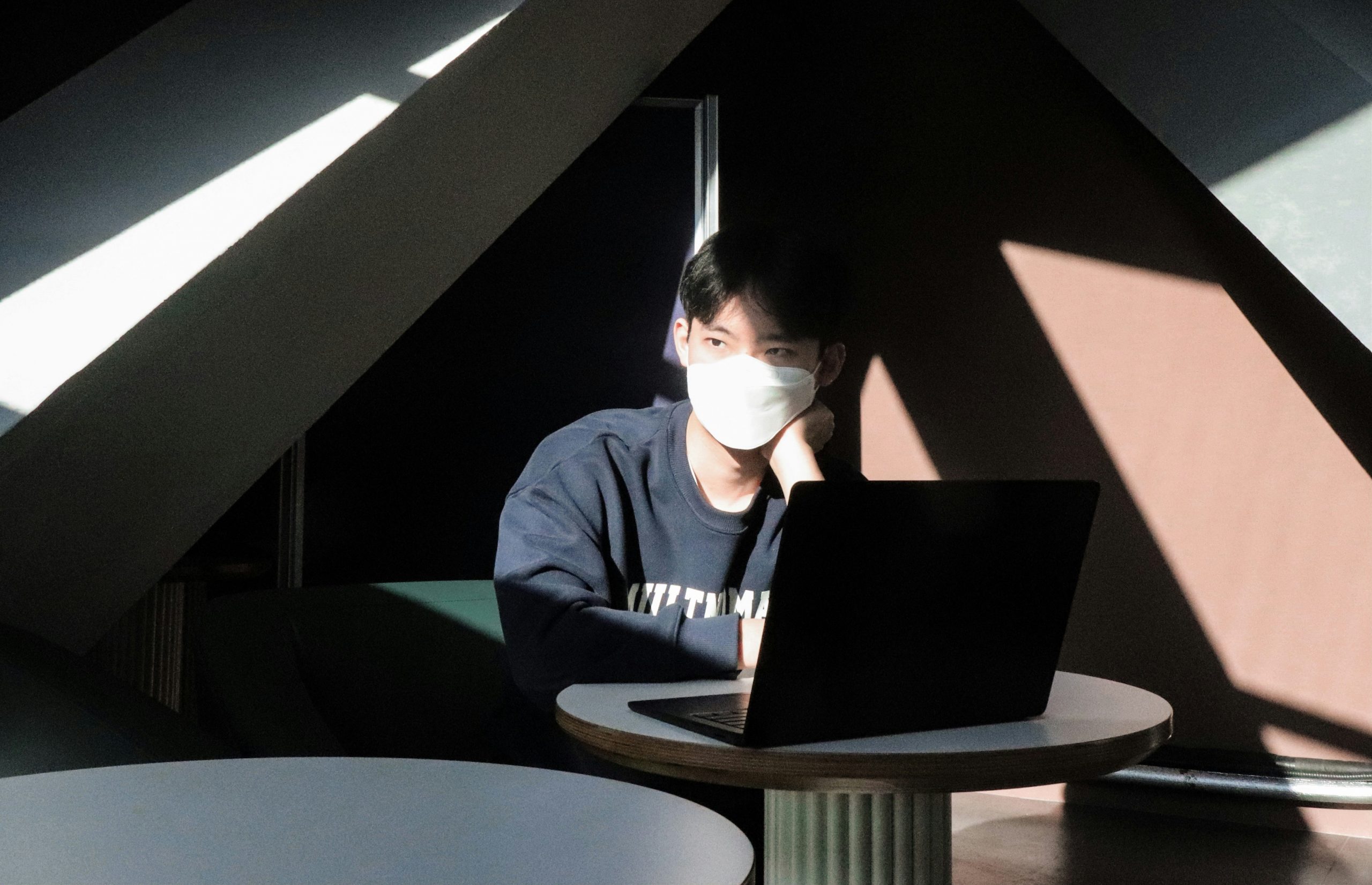 Close up of a architect hands working on thermal isolation plans next to a laptop