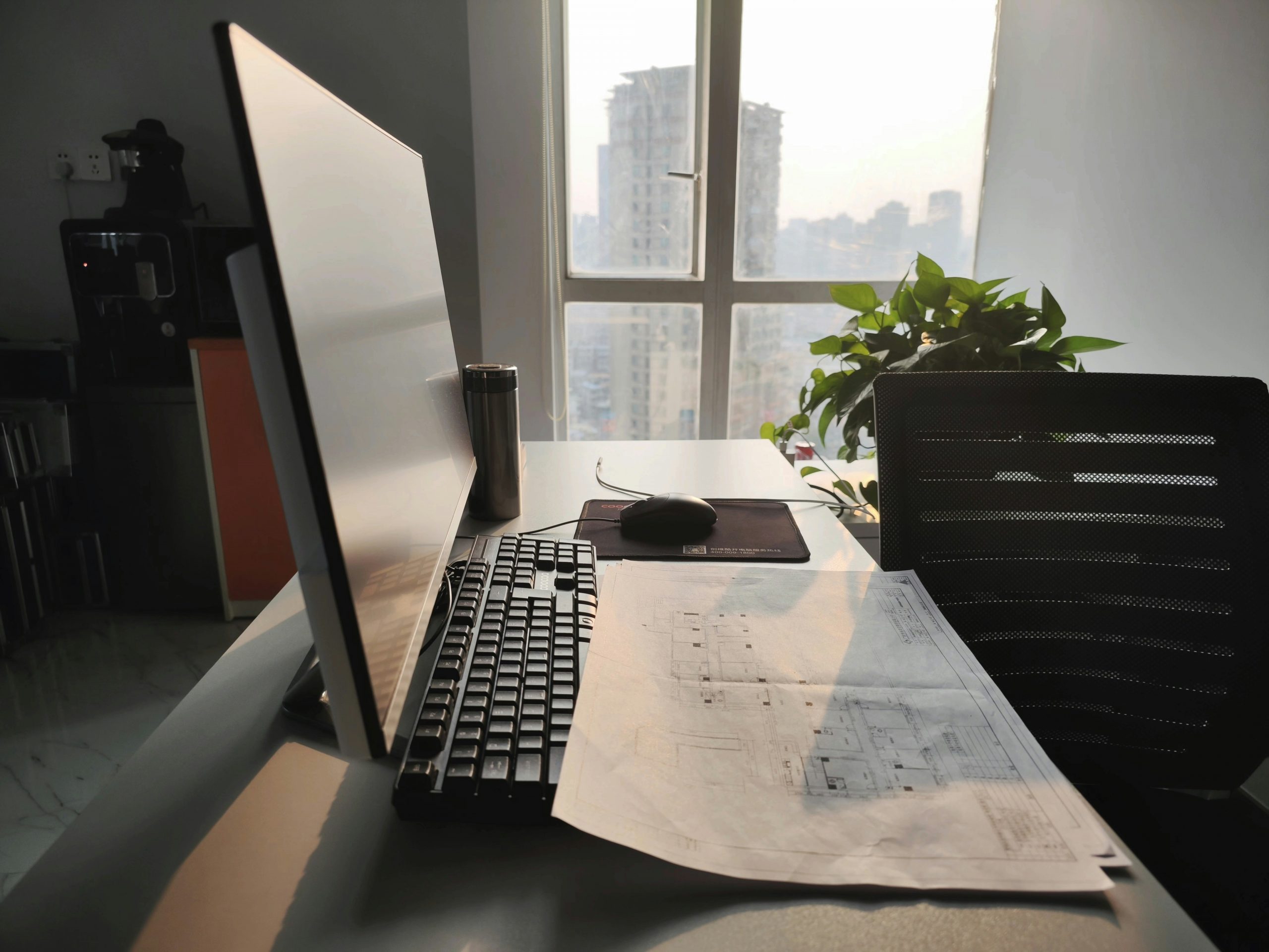 A stressed office manager in a construction company buried under paperwork vs a simplified digital workflow on a tablet