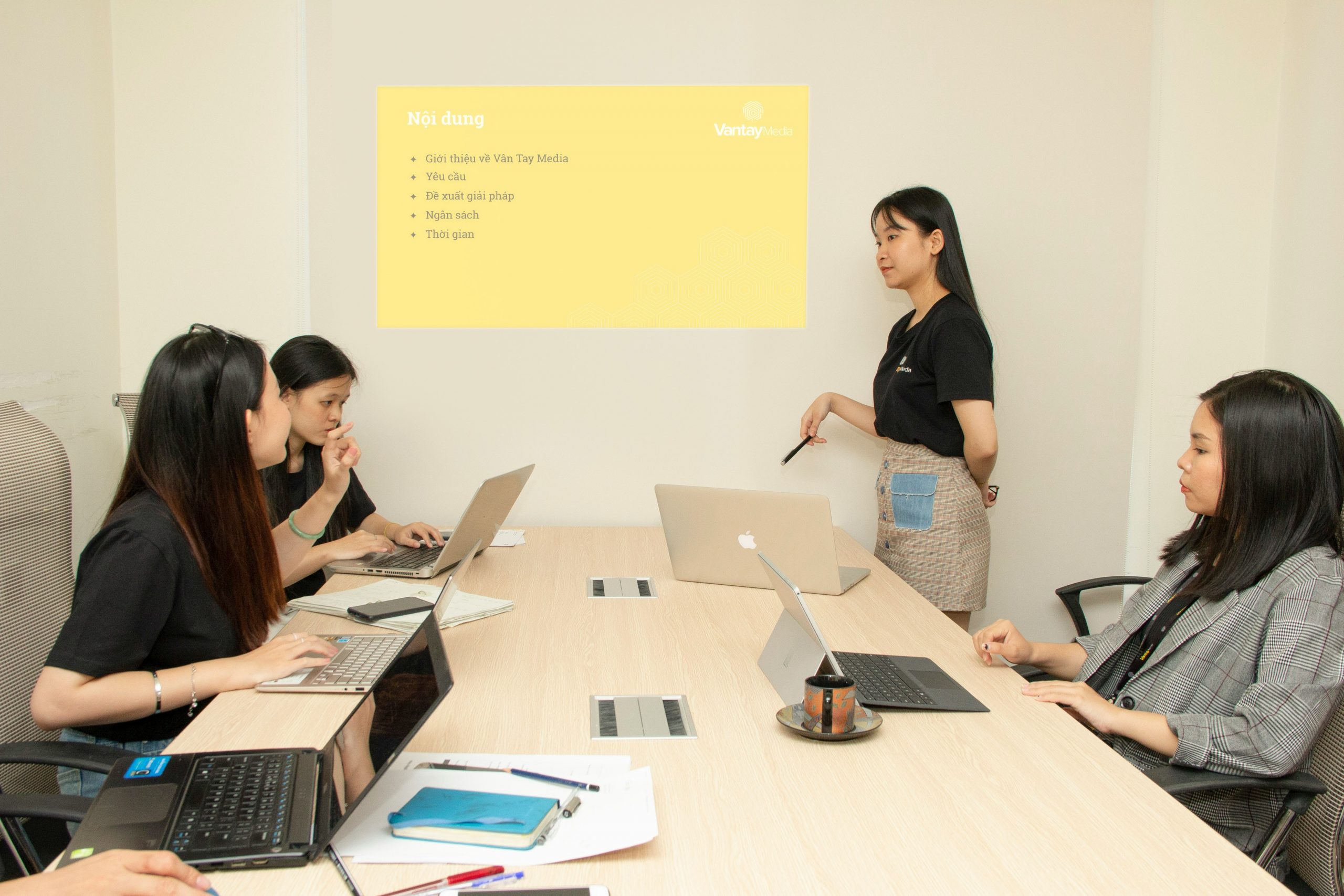 Team meeting in an office discussing software options on a whiteboard