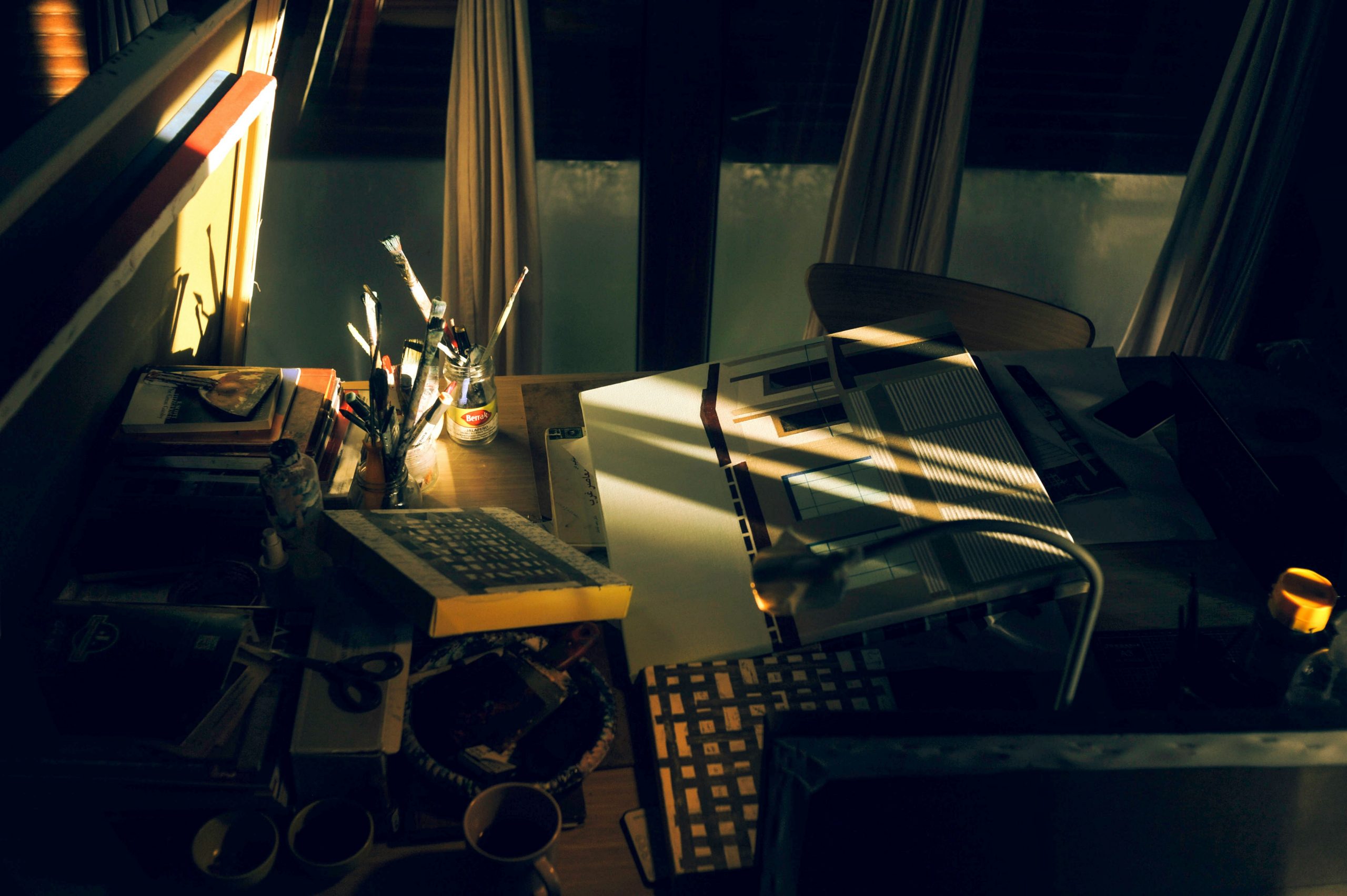 High angle shot of a messy desk with papers and calculator versus a clean desk with just a laptop showing a CRM interface