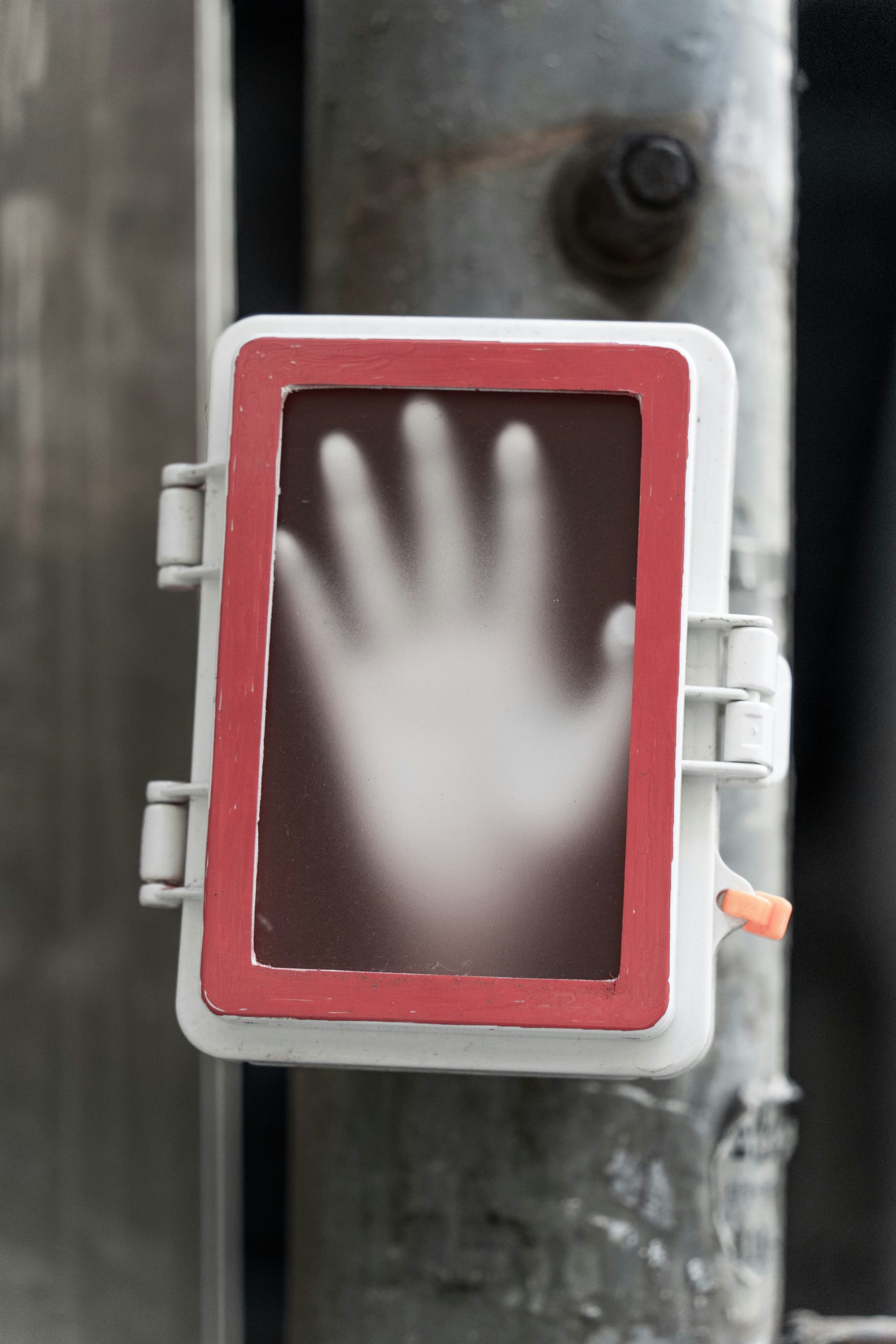 Close up of hands holding a smartphone displaying a digital signature screen and validation button.