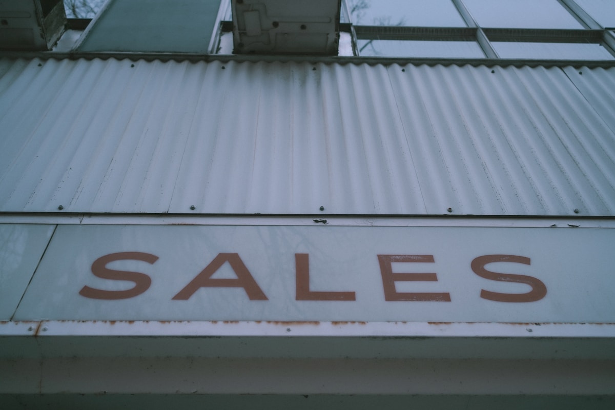 a sign that says sales on the side of a building