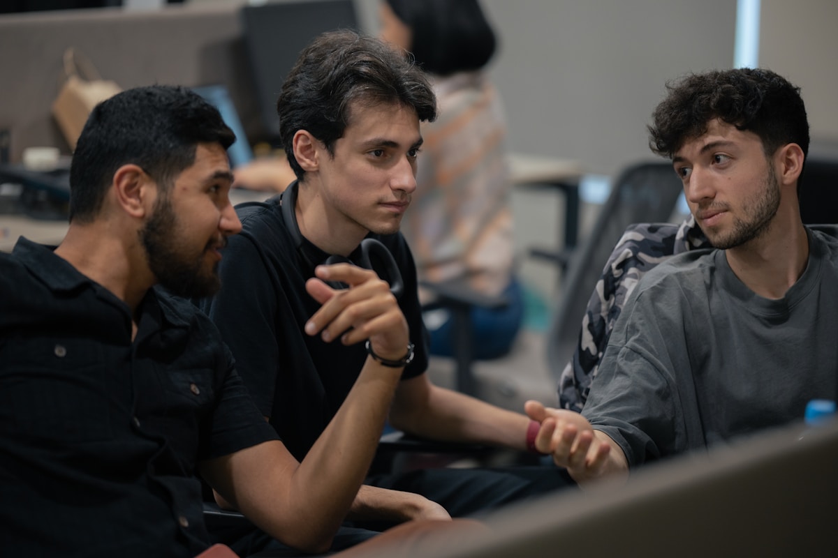 A group of men sitting next to each other