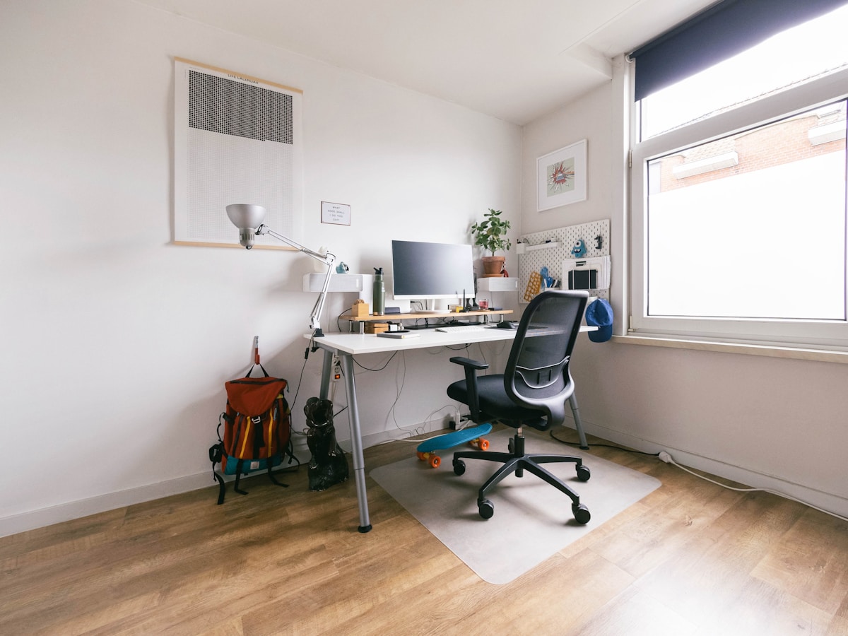 Bureau de travail moderne et organisé avec ordinateur et accessoires.